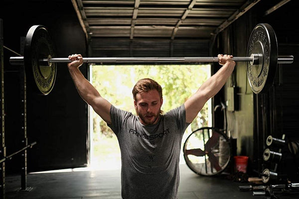 Man holding barbell with bumpers