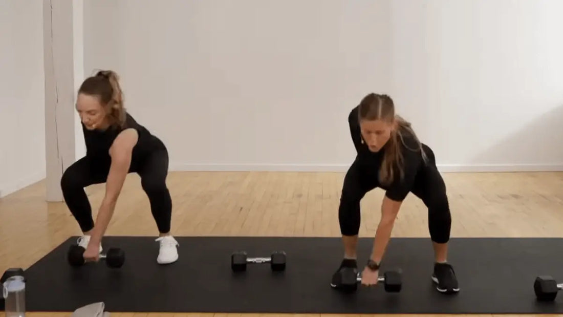 2 females doing functional strength training with dumbbells
