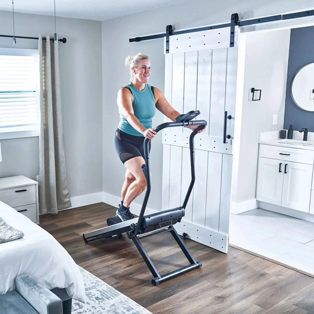 Lifestyle image of female on echelon stair climber in a bedroom