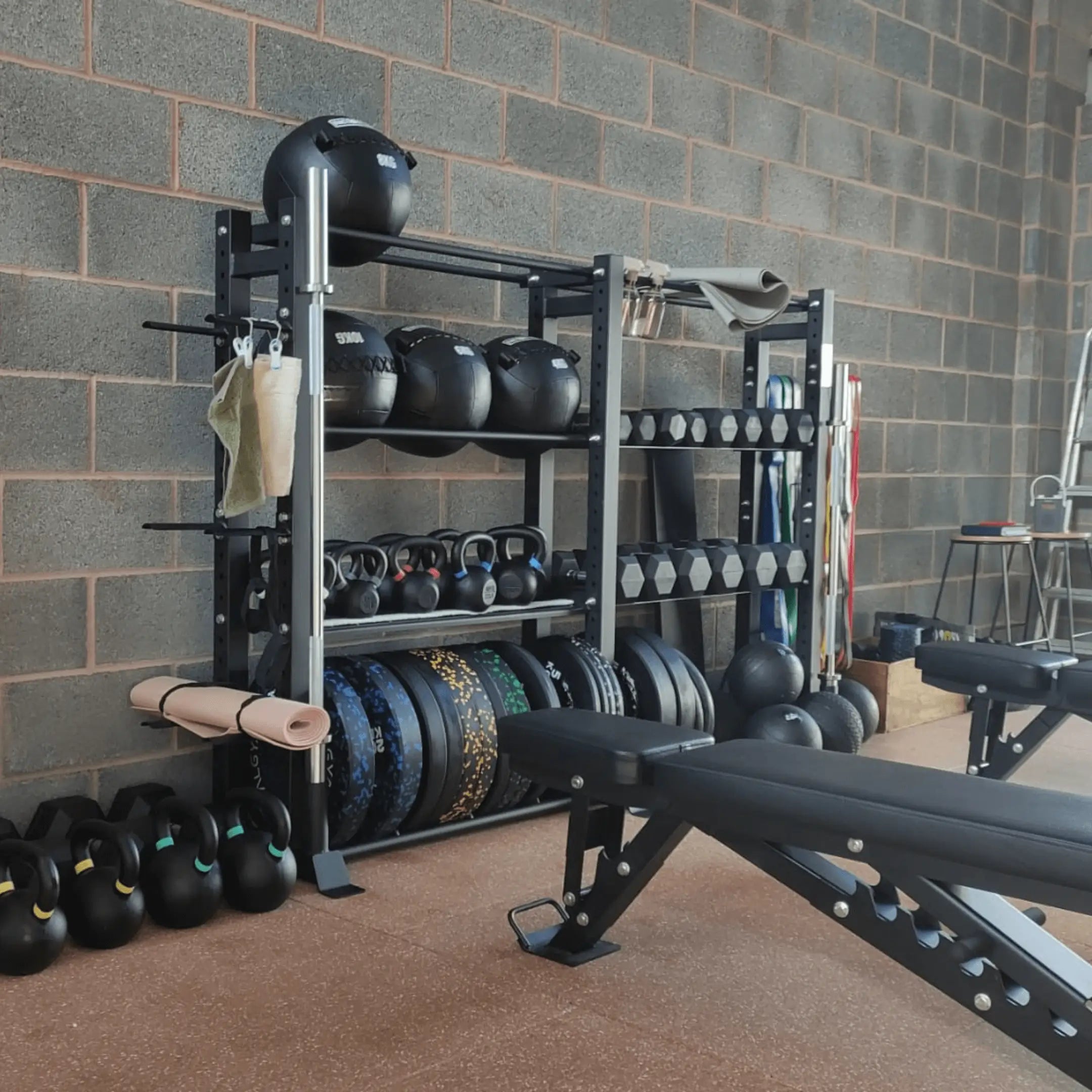 Image of a gym storage rack with free weights on it.